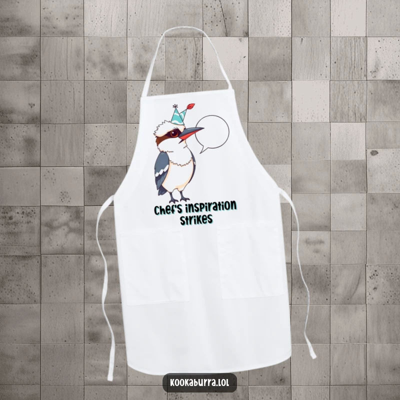 Funny Kookaburra Apron: Whimsical bird in a party hat, quill ready, pointing at a blank speech bubble, perfect for a funny cook.