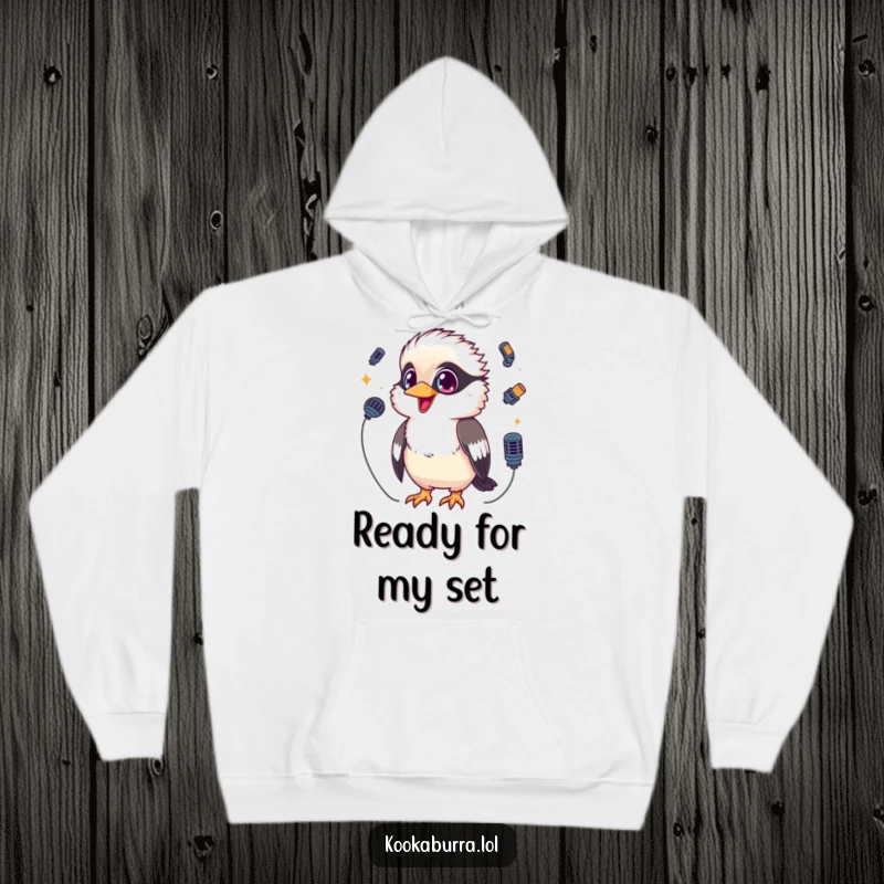 Funny Kookaburra Hoodie depicting a kawaii kookaburra with sparkling eyes, juggling tiny microphones, perfect for cozy performances.
