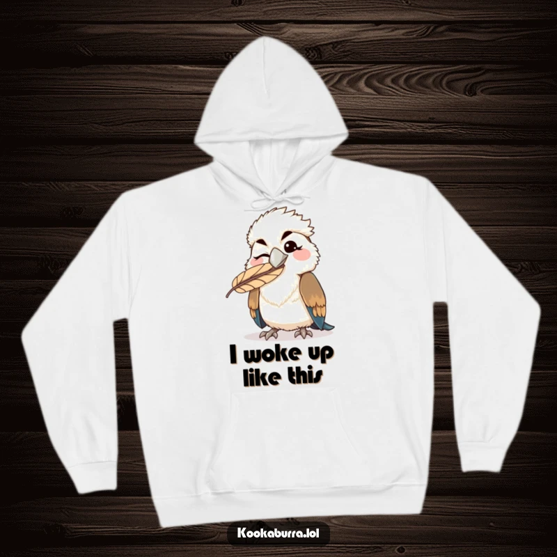 Funny kawaii kookaburra hoodie, a bird winking with a feather comically stuck on its beak, perfect for cozy, humorous wear.