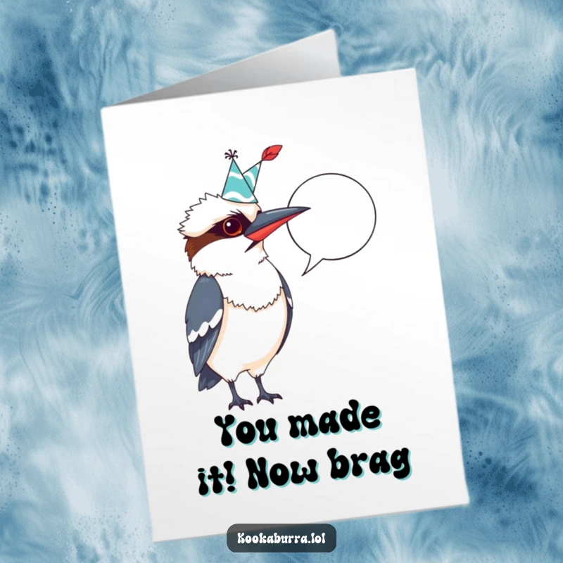 Funny Free Printable Congratulations Card: Kookaburra in party hat, quill poised over a blank speech bubble for personalized jokes.