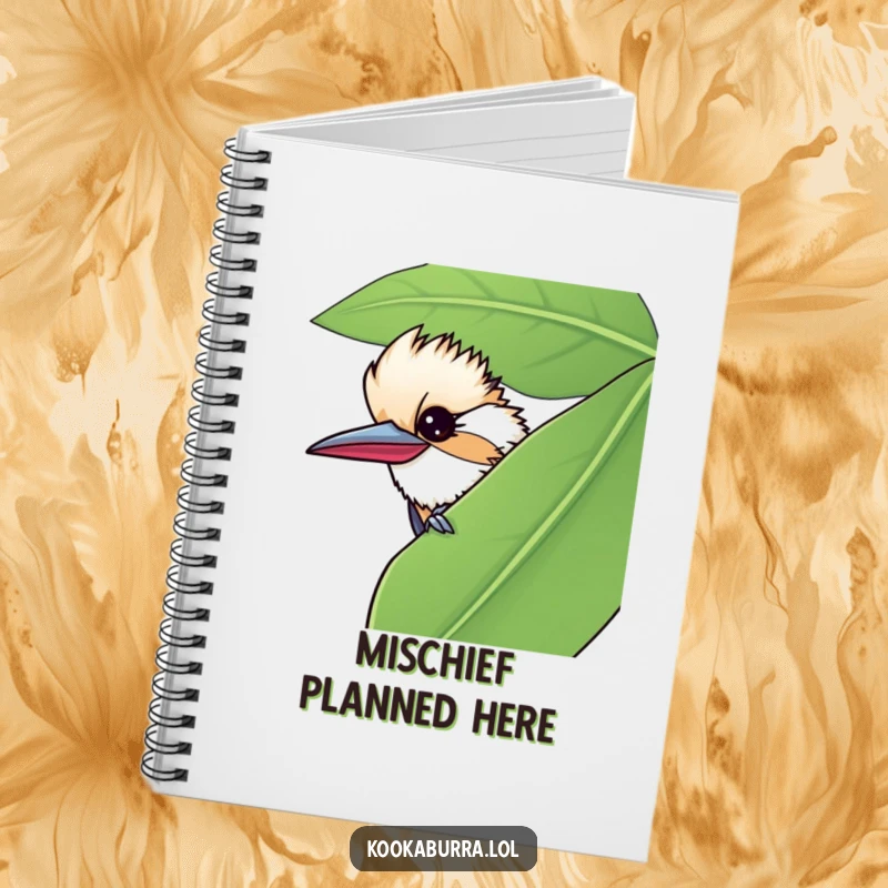 Funny notebook featuring a kookaburra peeking from behind a leaf, giving a mischievous wink for secretive note-taking.