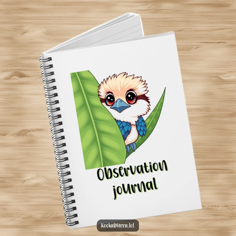 Funny kookaburra notebook cover featuring a bird with large eyes, peeking from behind a leaf.