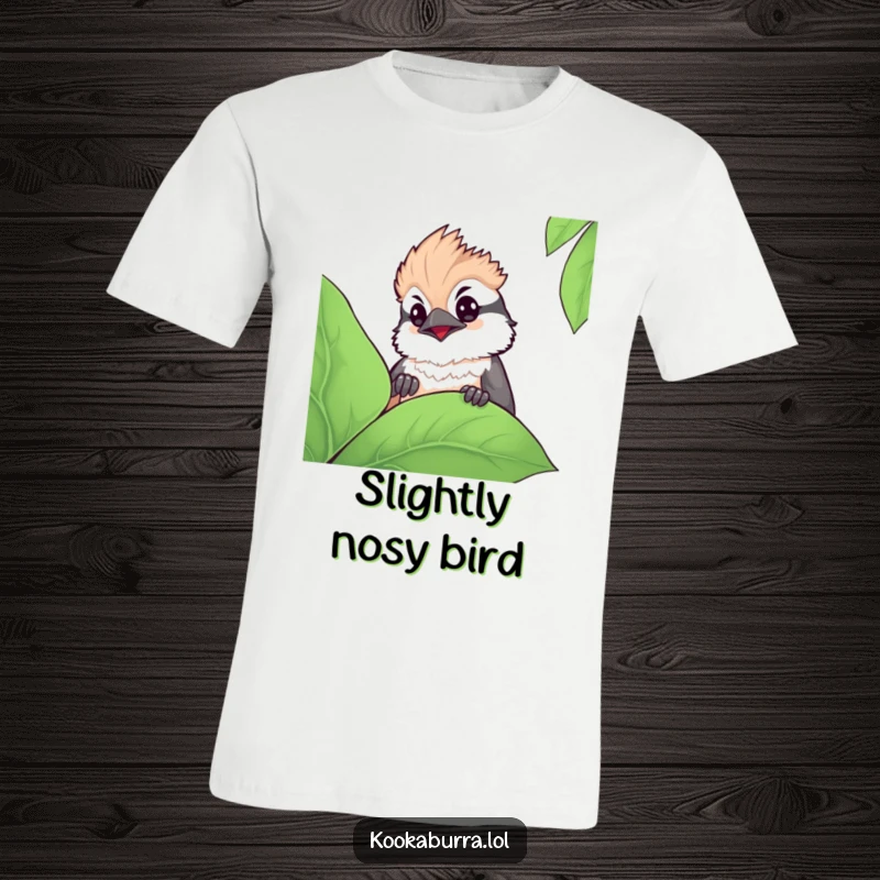 Funny kawaii kookaburra t-shirt depicting a cute bird with a curious expression peeking from behind a large leaf, showcasing sweetness.